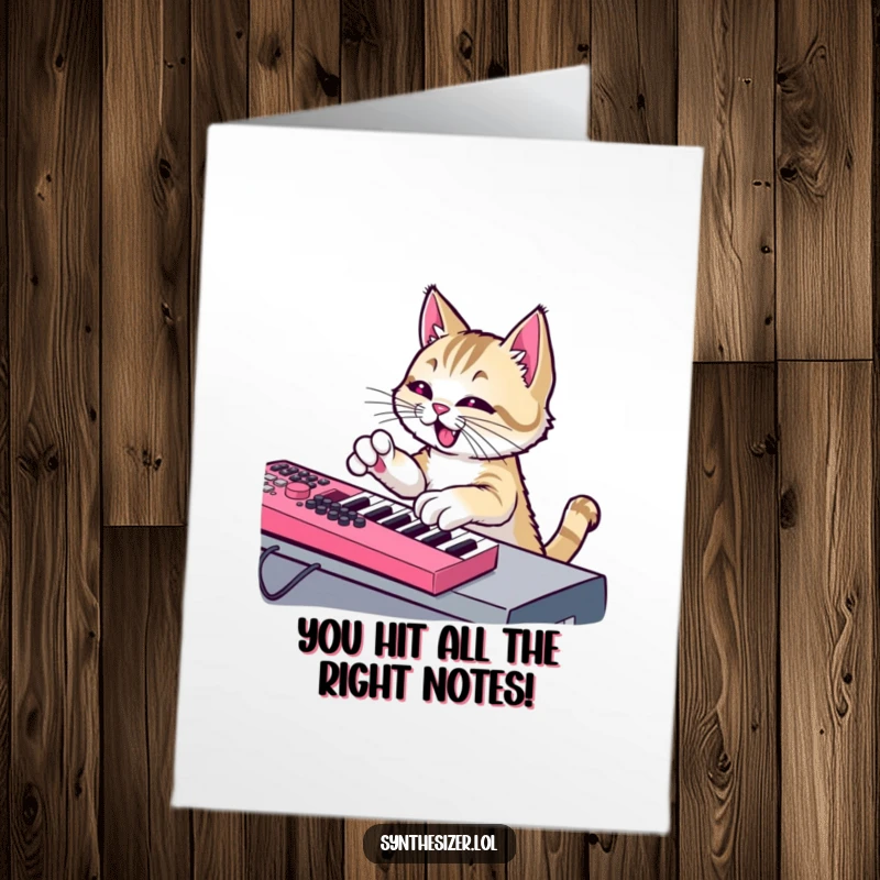 Funny Free Printable Congratulations Card of a mischievous cat playing a synthesizer keyboard.